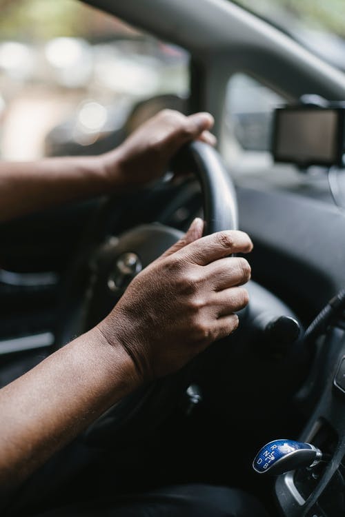 picture of a pair of hands on a Toyota steering wheel